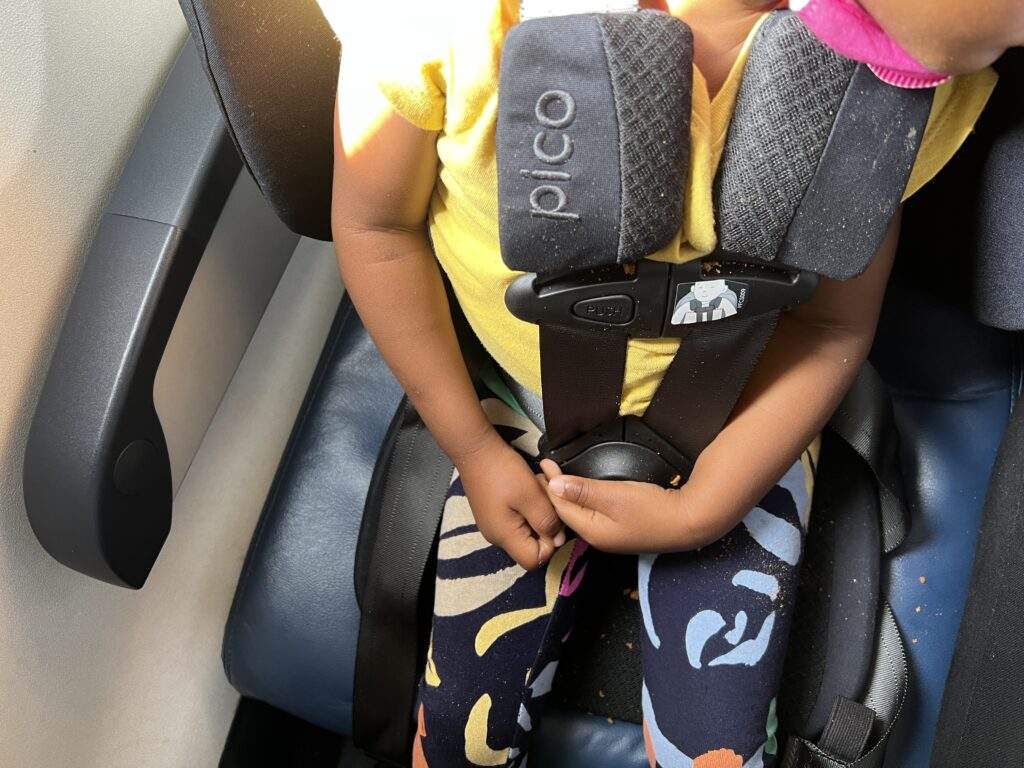 Toddler in car seat on plane