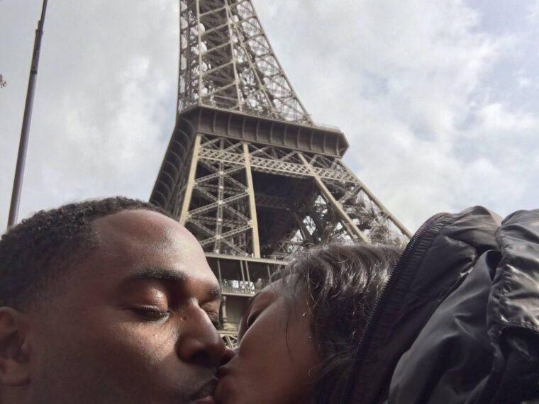 Black couple romantic photo in front of the Eiffel Tower