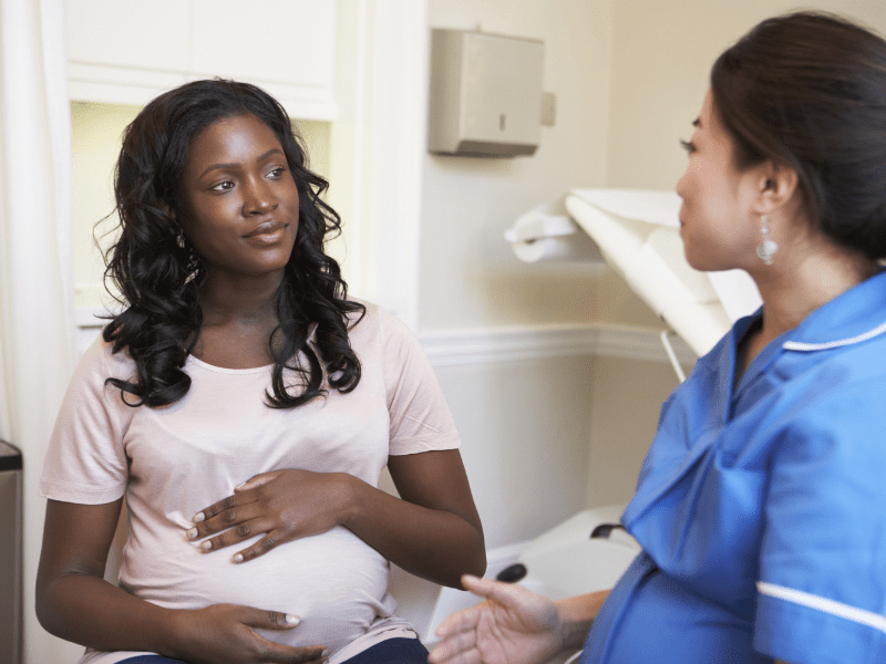 Pregnant African American Woman with Doctor