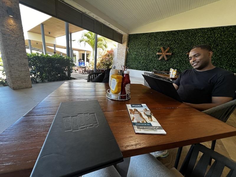 My husband checking out the menu items from SCORE. Antigua Hotels