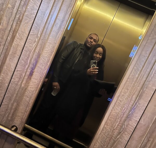 Black couple dressed elegantly in Four Seasons New Orleans elevator heading out for date night. luxury weekend in New Orleans